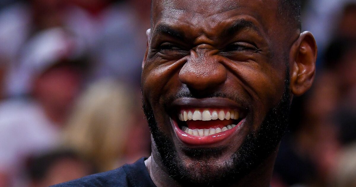 LeBron James #23 of the Cleveland Cavaliers laughs from the bench during the first half of the game against the Miami Heat at the American Airlines Arena on April 10, 2017 in Miami, Florida.