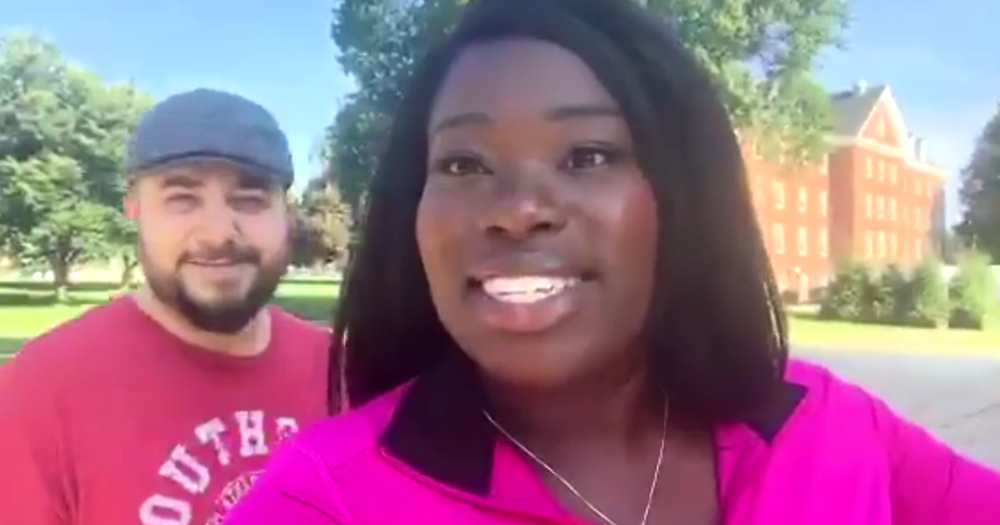 Mom wearing a bright pink shirt wandering around the college campus