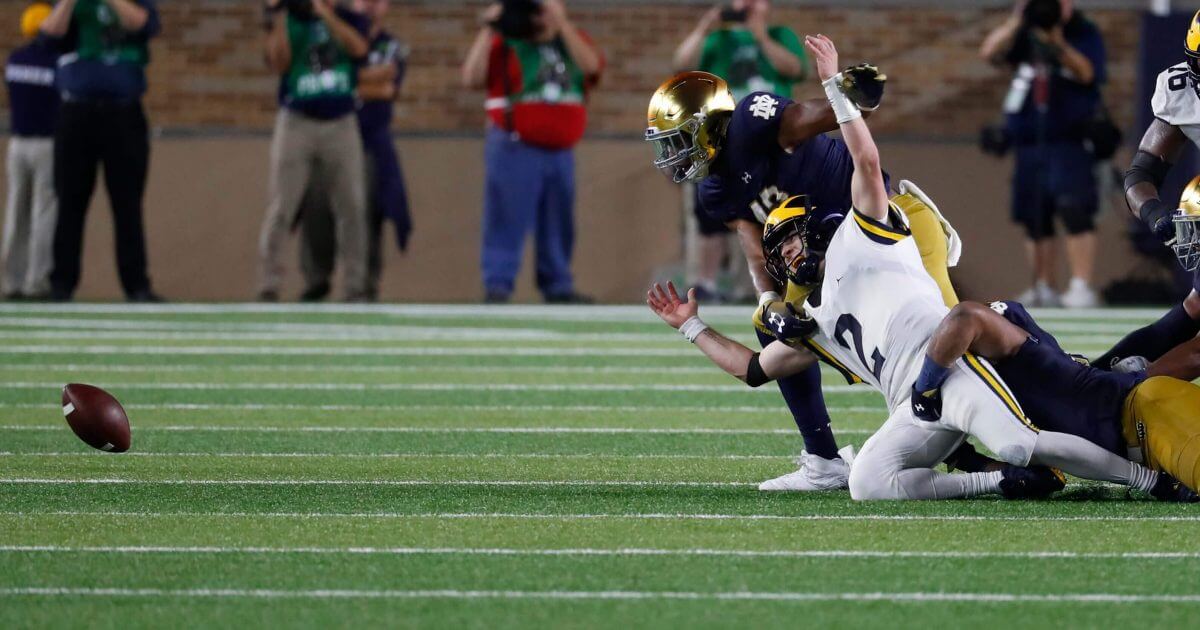 Michigan quarterback Shea Patterson (2) fumbles the ball against Notre Dame in the first half of Michigan's loss at South Bend, Indiana on Saturday