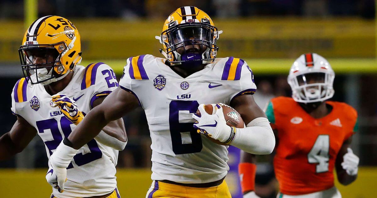 LSU linebacker Jacob Phillips returns an interception for a touchdown during the first half of an NCAA college football game Sunday, Sept. 2, 2018, in Arlington, Texas.