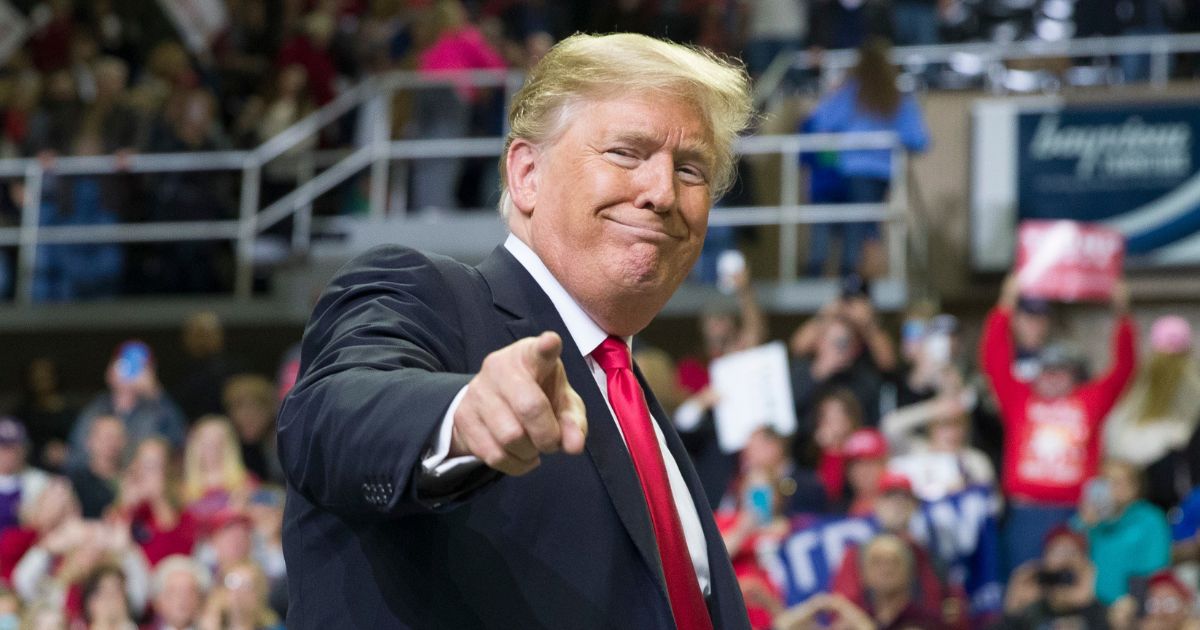 President Donald Trump points to a supporter during a rally at the Mississippi Coast Coliseum in Biloxi on Nov. 26, 2018.