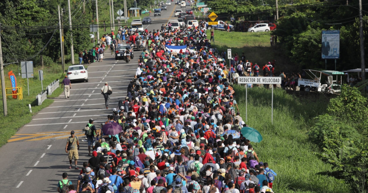 Thousands of people in a migrant caravan walk into the interior of Mexico after crossing the Guatemalan border Sunday near Ciudad Hidalgo, Mexico.