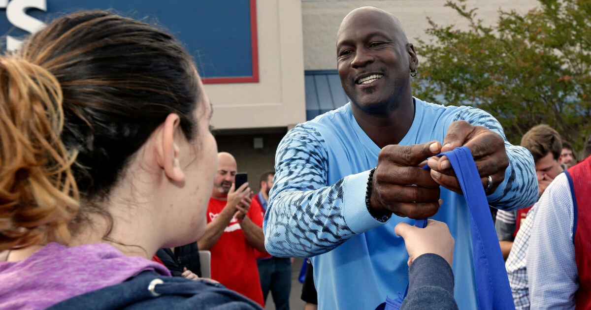 NBA legend Michael Jordan greets people and hands out food for Thanksgiving to members of the community in Wilmington, North Carolina, on Tuesday.