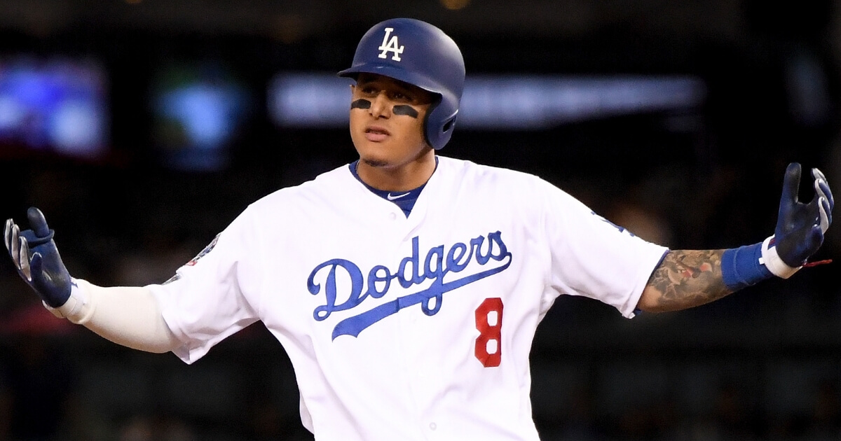 Manny Machado, then with the Los Angeles Dodgers, reacts after hitting a double against the Milwaukee Brewers in Game 3 of the NL Championship Series on Oct. 15.