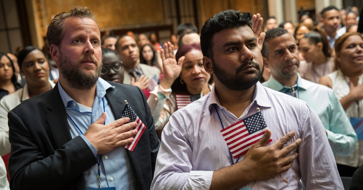 New U.S. citizens recite the Pledge of Allegiance during naturalization ceremony.