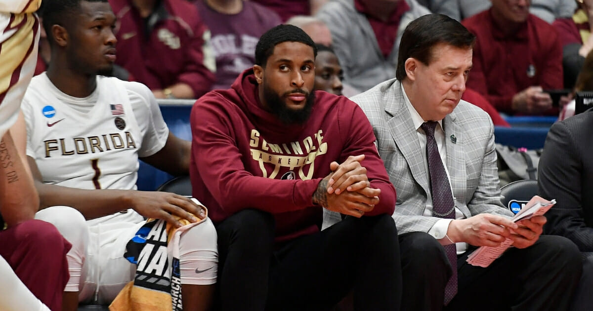 Florida State's Phil Cofer sits on the bench with a boot on his right foot during Seminoles' first-round NCAA Tournament game against Vermont on March 21, 2019.