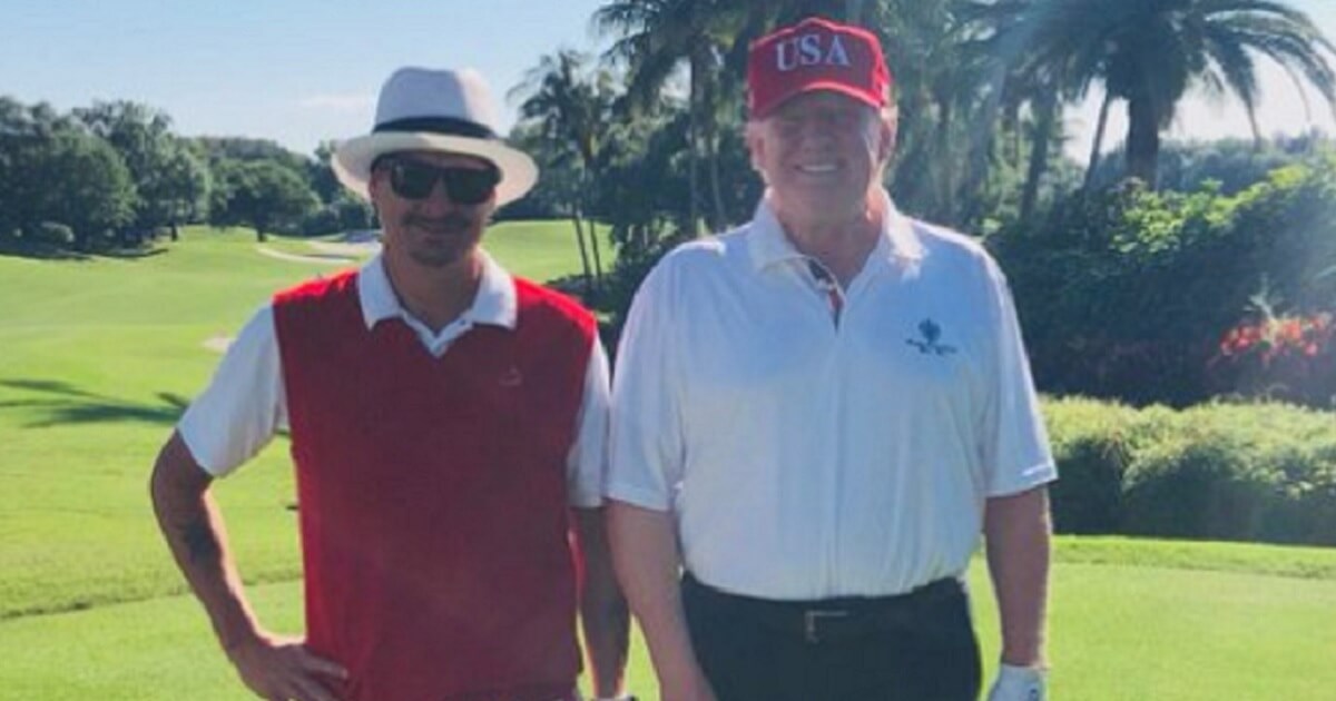 Rapper Kid Rock, left, and President Donald Trump, right, post for a golf course picture.