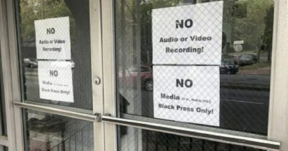 Signs posted on the doors of the Bolten Street Baptist Church in Savannah, Georgia, are seen during a meeting coordinated to garner support for one black candidate in the city's upcoming mayoral race.