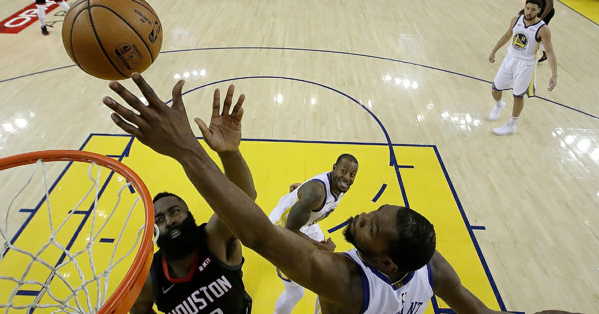 Kevin Durant of the Golden State Warriors blocks a shot by the Houston Rockets' James Harden.