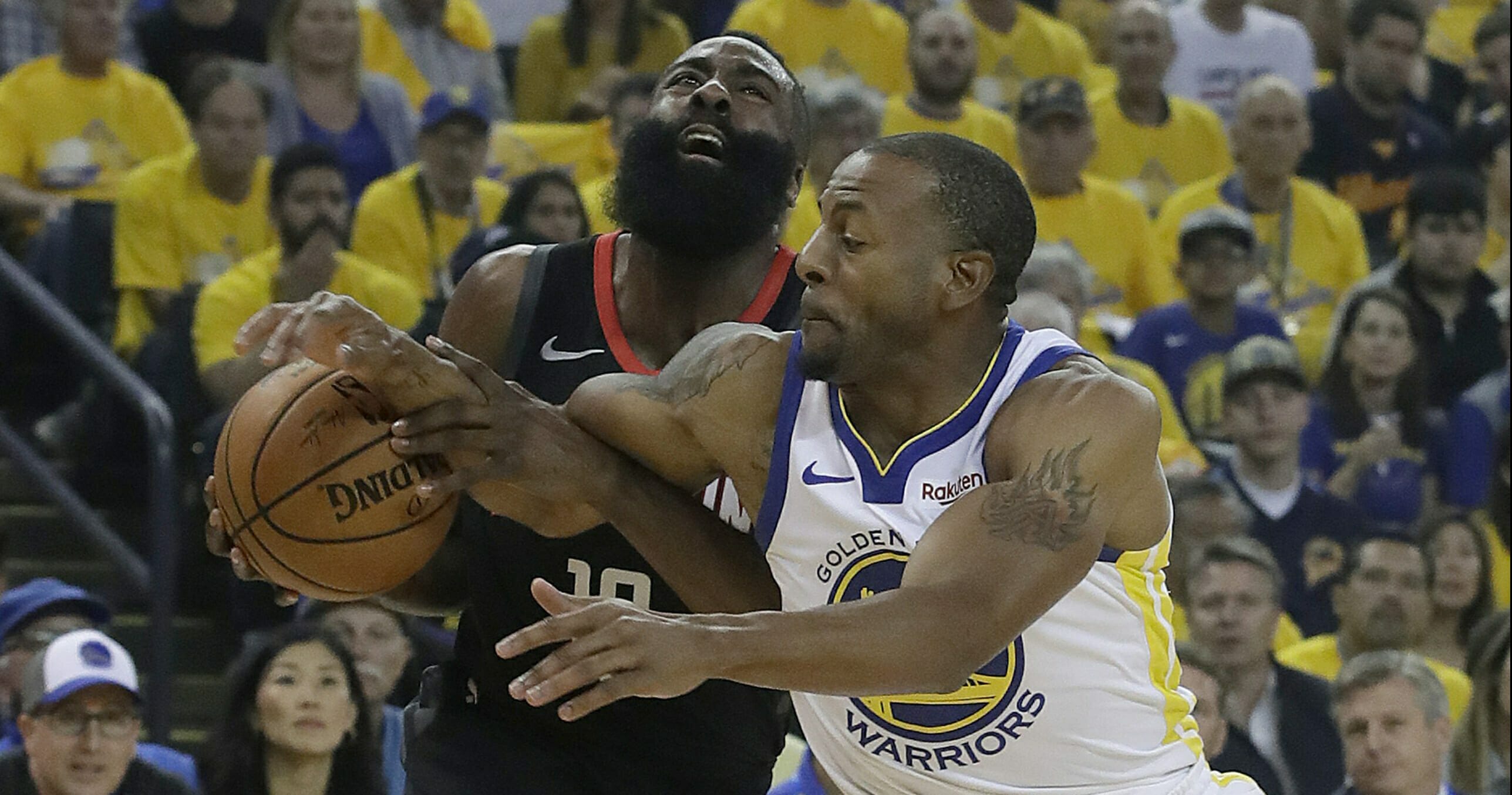 Houston Rockets guard James Harden, left, is fouled by Golden State Warriors guard Andre Iguodala.