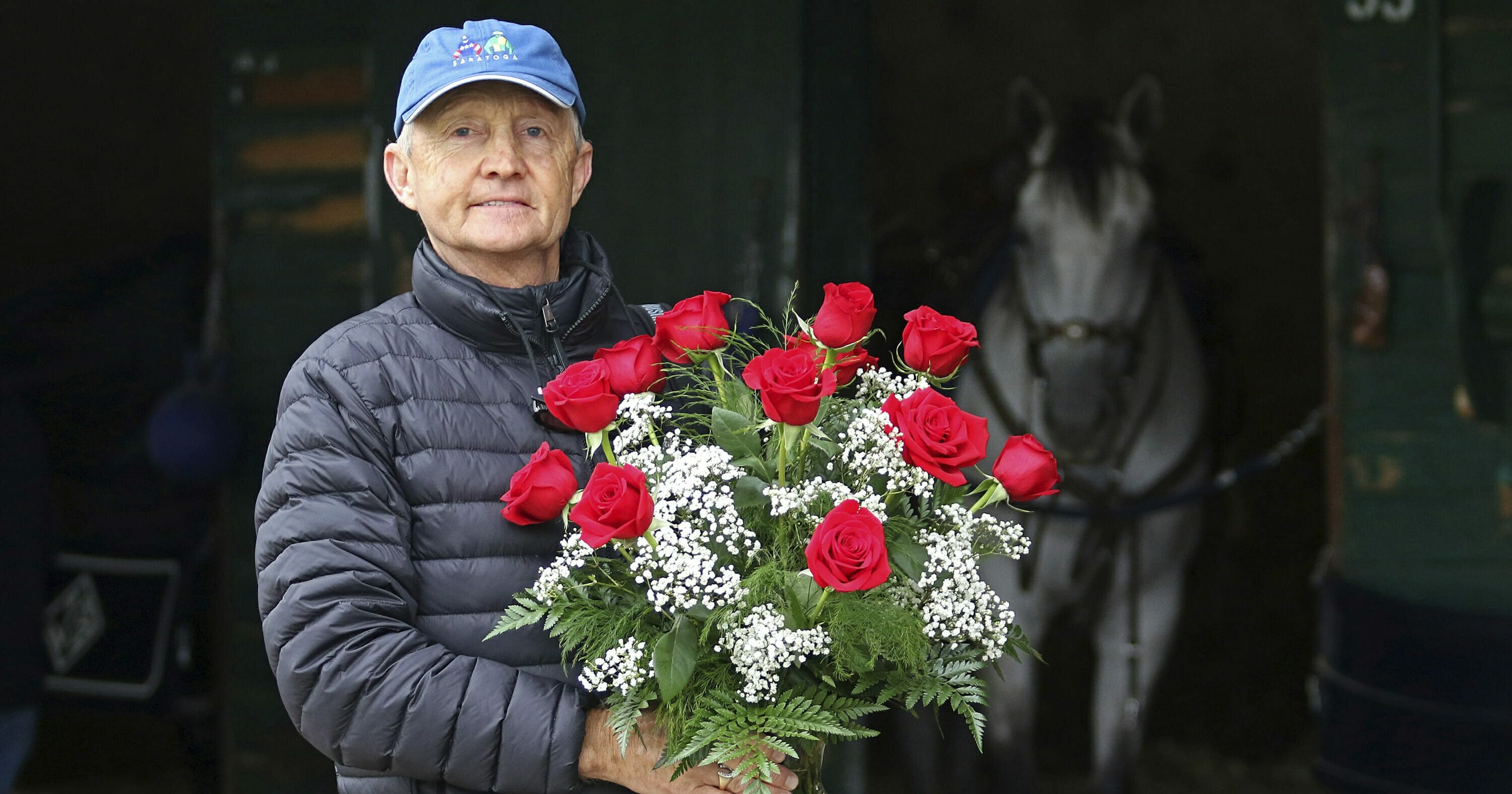 Jason Servis, trainer of Maximum Security, who was disqualified from first place in the Kentucky Derby, stands outside his barn at Monmouth Park on May 9, 2019 with a dozen roses.