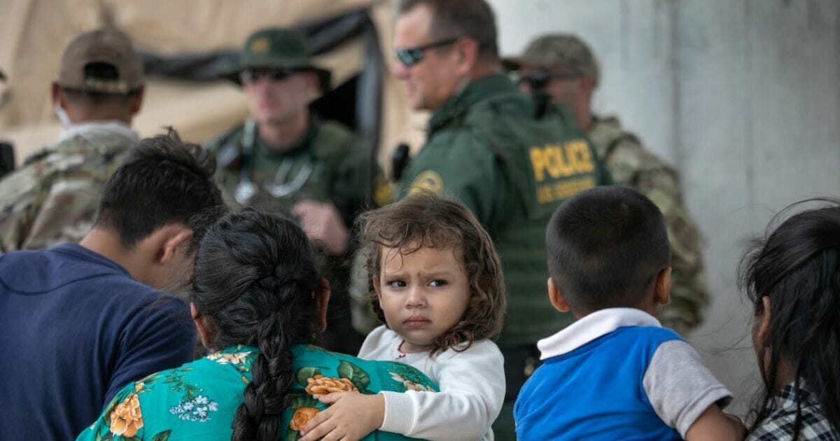 Immigrants are taken into custody by Border Patrol agents in McAllen, Texas