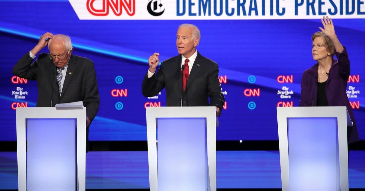 Sen. Bernie Sanders, former Vice President Joe Biden, and Sen. Elizabeth Warren react during the Democratic Presidential Debate at Otterbein University on Oct. 15, 2019 in Westerville, Ohio.