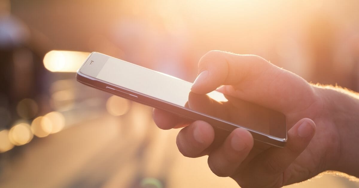 A person holding a smartphone.