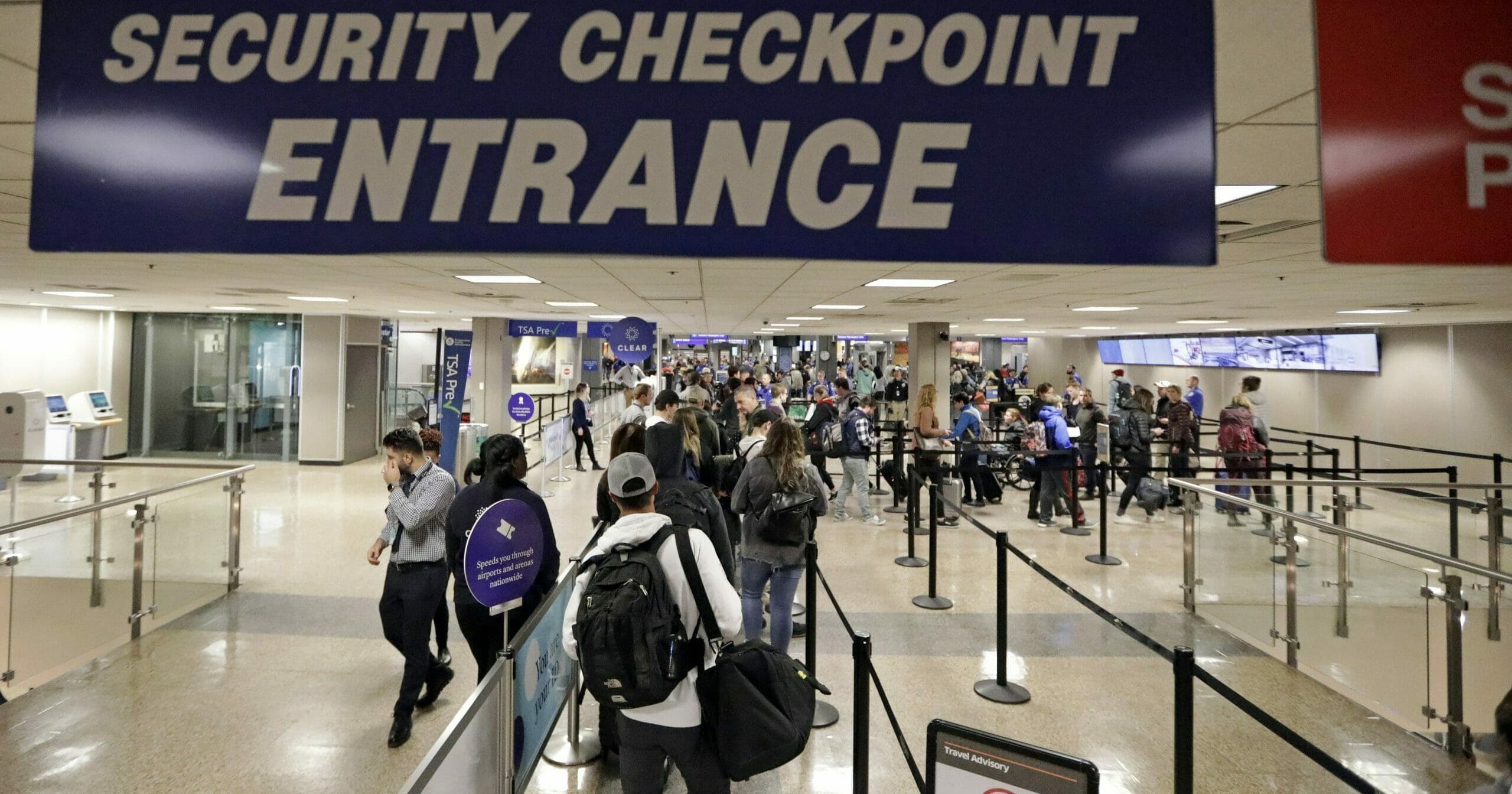 In this Nov. 27, 2019, file photo, travelers walk through a security checkpoint in Terminal 2 at Salt Lake City International Airport in Salt Lake City.