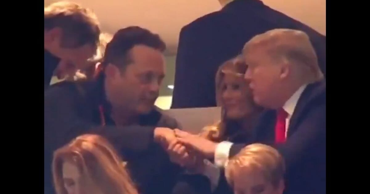 Actor Vince Vaughn shakes hands with President Donald Trump during the College Football Playoff championship game Jan. 13, 2020, in New Orleans.