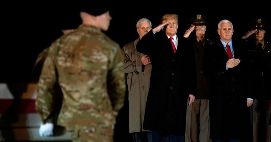 President Donald Trump and Vice President Mike Pence observe the dignified transfer of two U.S. soldiers, killed in Afghanistan, at Dover Air Force Base in Delaware, on Feb. 10, 2020.