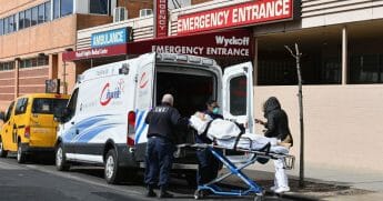 Paramedics transport a patient to the emergency room entrance of the Wyckoff Heights Medical Center in Brooklyn on April 2, 2020, in New York.