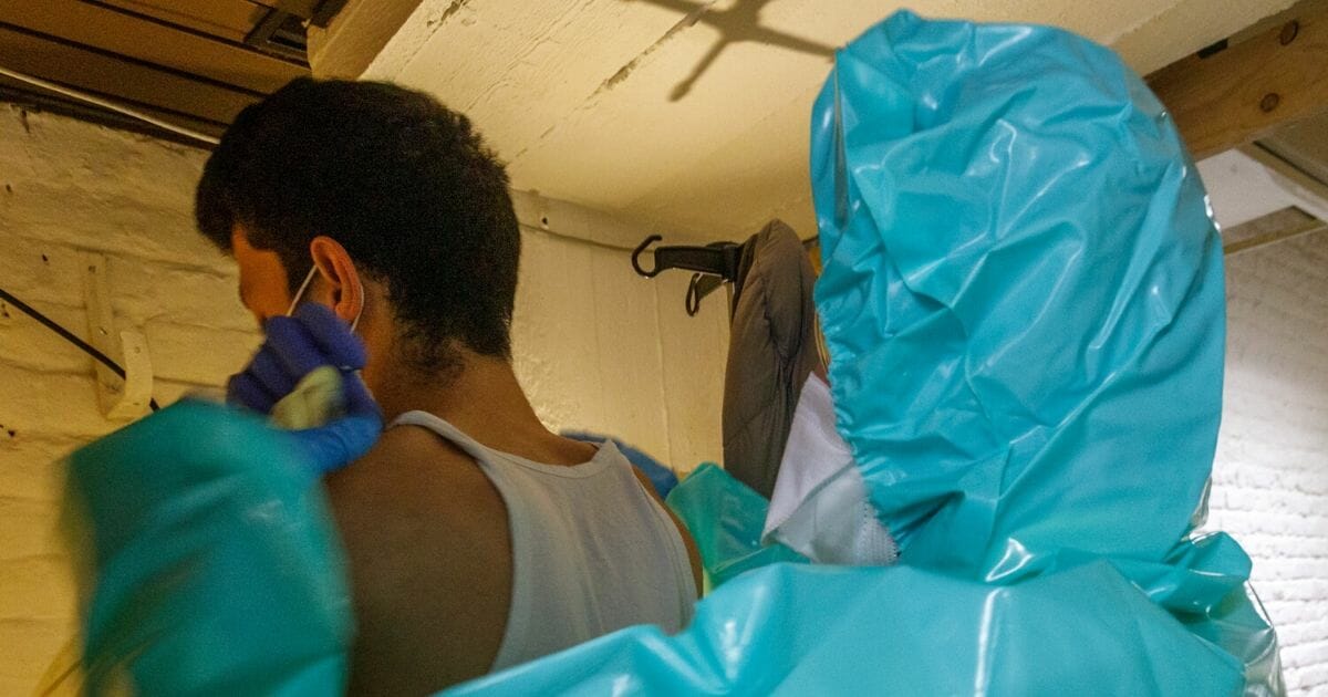 A man with coronavirus symptoms gets a sterile dressing by a paramedic in the makeshift basement of the Klinicare COVID-19 Diagnostic Center on April 2, 2020, in Brussels, Belgium.
