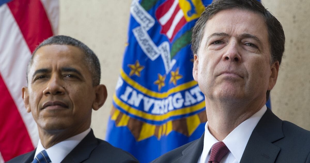Then-President Barack Obama sits alongside then-newly sworn-in FBI Director James Comey during an installation ceremony at the FBI headquarters in Washington in 2013.