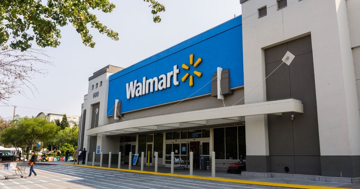 People going in and coming out of a Walmart store on a sunny day in Mountain View, California.