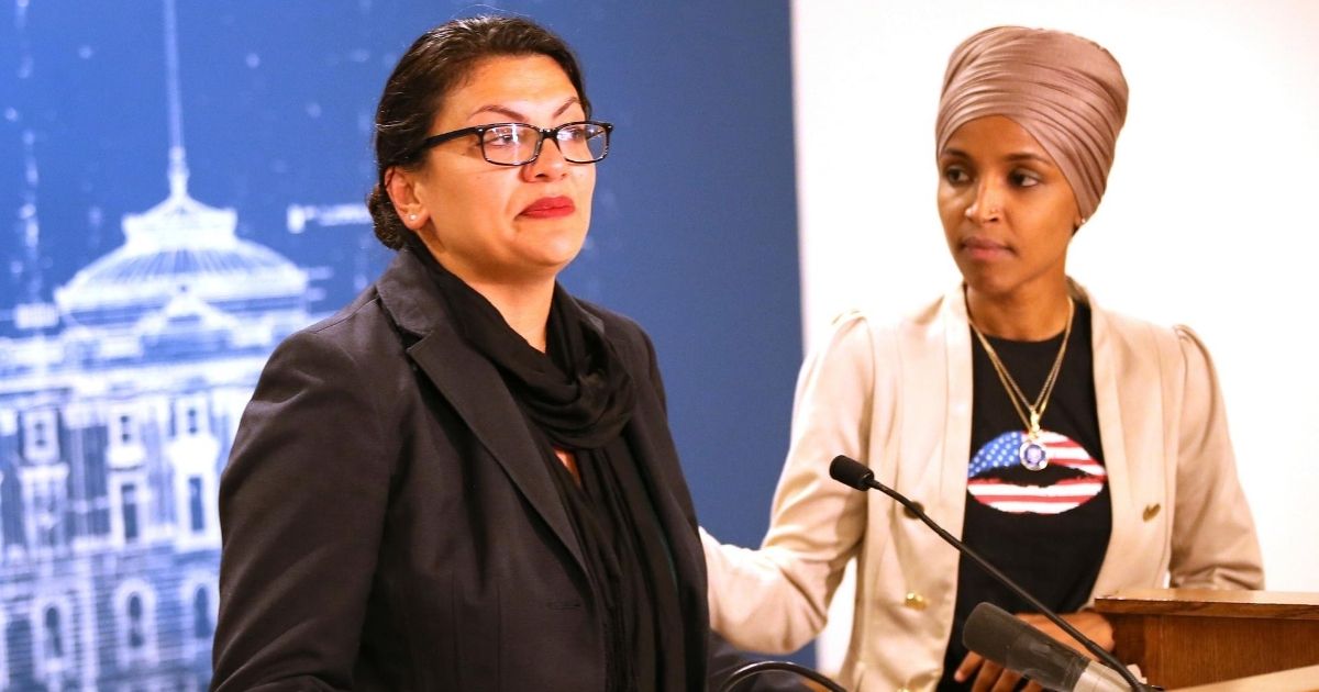 Democratic Minnesota Rep. Ilhan Omar, right, consoles Democratic Michigan Rep. Rashida Tlaib during a news conference on Aug. 19, 2019, at the State Capitol in St. Paul, Minnesota.
