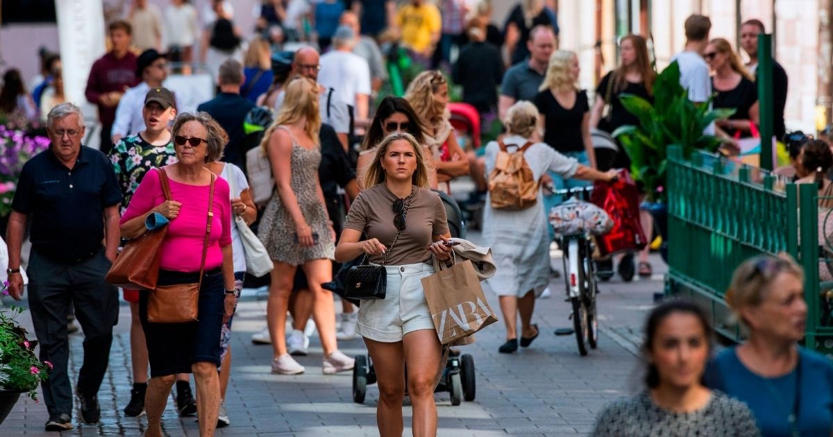 People walk down a street in Stockholm on July 27, 2020, during the coronavirus pandemic.