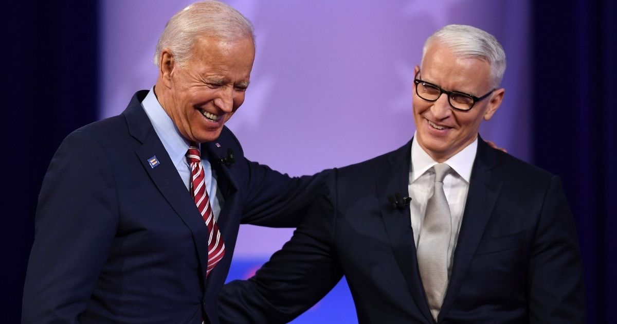 Democratic presidential hopeful former US Vice President Joe Biden (L) laughs with moderator CNN's Anderson Cooper during a town hall devoted to LGBTQ issues hosted by CNN and the Human rights Campaign Foundation at The Novo in Los Angeles on October 10, 2019.