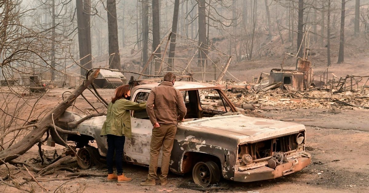 US Democratic vice presidential candidate and Senator Kamala Harris and California Governor Gavin Newsom view a property ravaged by the Creek Fire near Pine Ridge Elementary School on September 15, 2020 in an unincorparated area of Fresno, California.