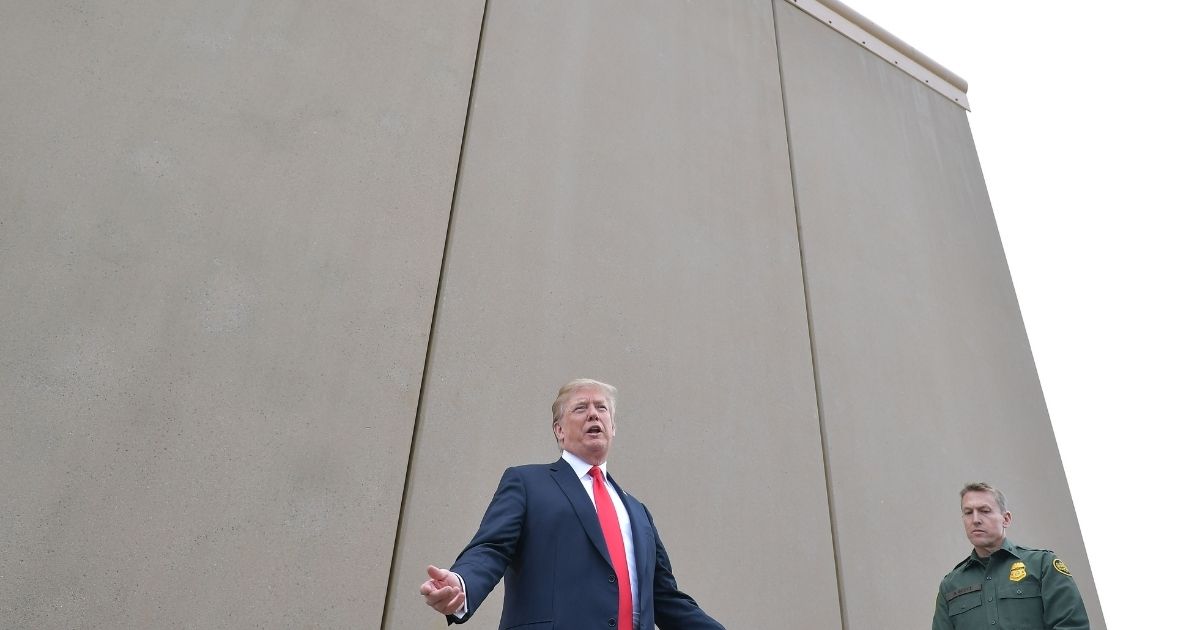 US President Donald Trump inspects border wall prototypes with Chief Patrol Agent Rodney S. Scott in San Diego, California on March 13, 2018.