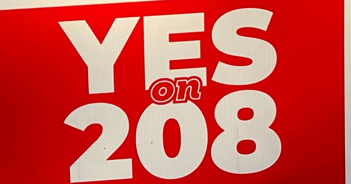 A yard sign promoting Proposition 208, a new Arizona tax initiative, is pictured above.