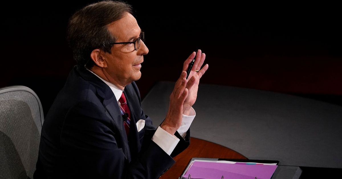 CLEVELAND, OHIO - SEPTEMBER 29: Moderator Chris Wallace of Fox News gestures toward President Donald Trump and former Vice President and Democratic presidential nominee Joe Biden at the Health Education Campus of Case Western Reserve University on September 29, 2020 in Cleveland, Ohio. This is the first of three planned debates between the two candidates in the lead up to the election on November 3.