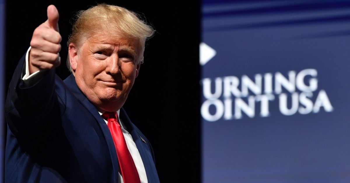 TOPSHOT - US President Donald Trump gestures during the Turning Point USA Student Action Summit at the Palm Beach County Convention Center in West Palm Beach, Florida on December 21, 2019.