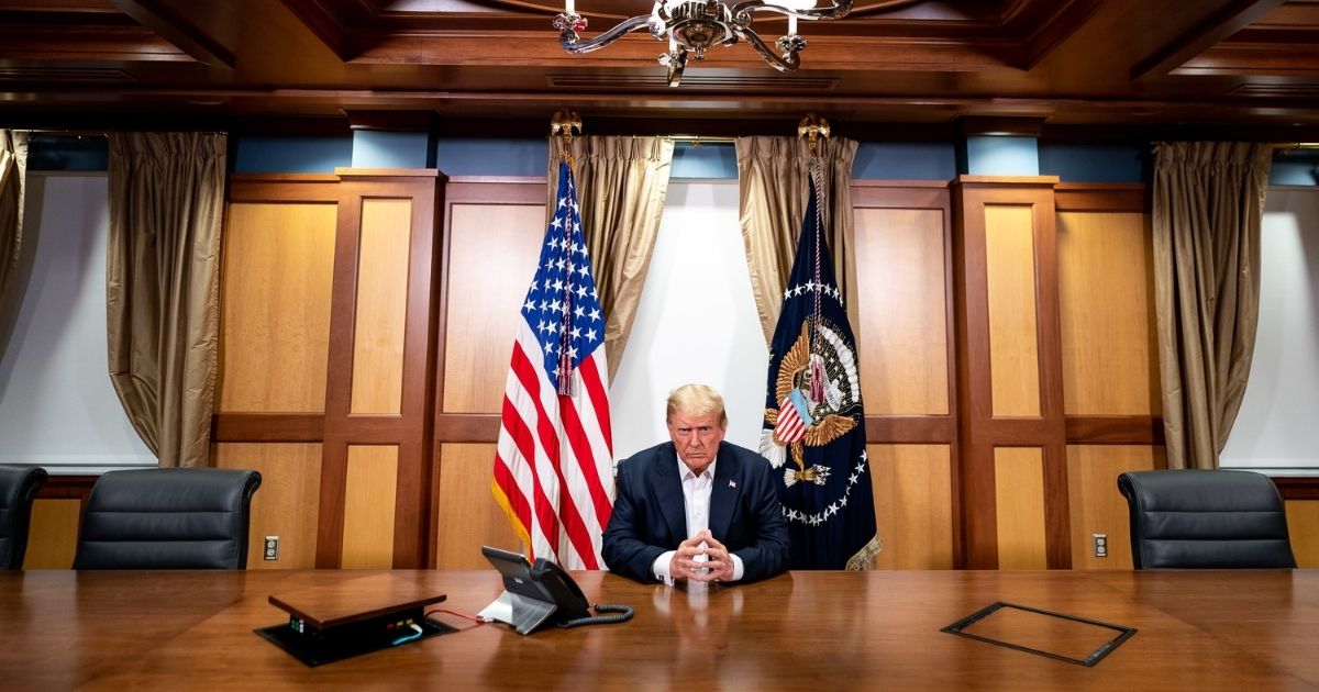 BETHESDA, MD - OCTOBER 04: In this handout provided by The White House, President Donald Trump participates in a phone call with Vice President Mike Pence, Secretary of State Mike Pompeo, and Chairman of the Joint Chiefs of Staff Gen. Mark Milley in his conference room at Walter Reed National Military Medical Center on October 4, 2020 in Bethesda, Maryland. Chief of Staff Mark Meadows (not pictured) is also present in the room on the call.