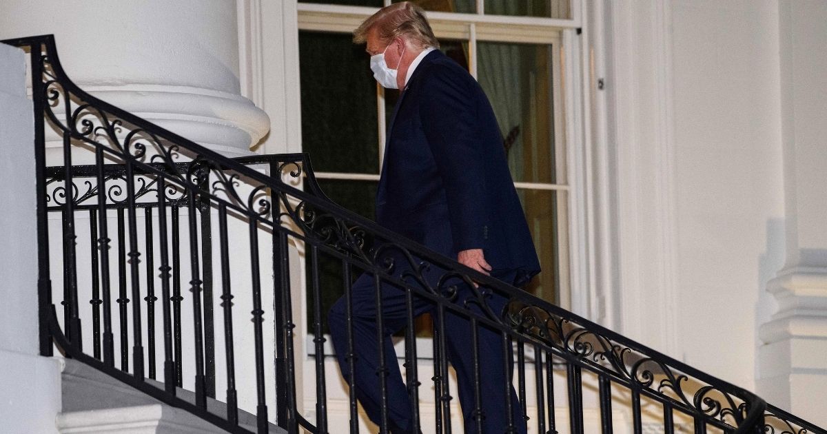 US President Donald Trump walks up the South Portico steps as he arrives at the White House upon his return from Walter Reed Medical Center, where he underwent treatment for Covid-19, in Washington, DC, on October 5, 2020.