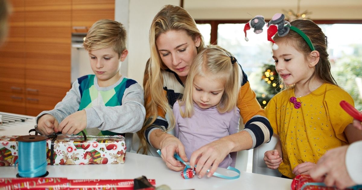 The above photo shows a family wrapping up Christmas presents.