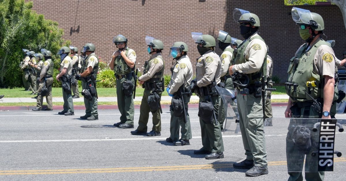 Officers from the West Hollywood Sheriff's Station are onsite at the All Black Lives Matter Solidarity March in Los Angeles on June 14, 2020. The police force budget in Los Angeles was cut by $150 million in July.