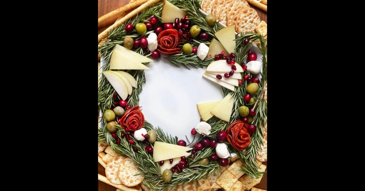 A charcuterie board arranged to look like a Christmas wreath.