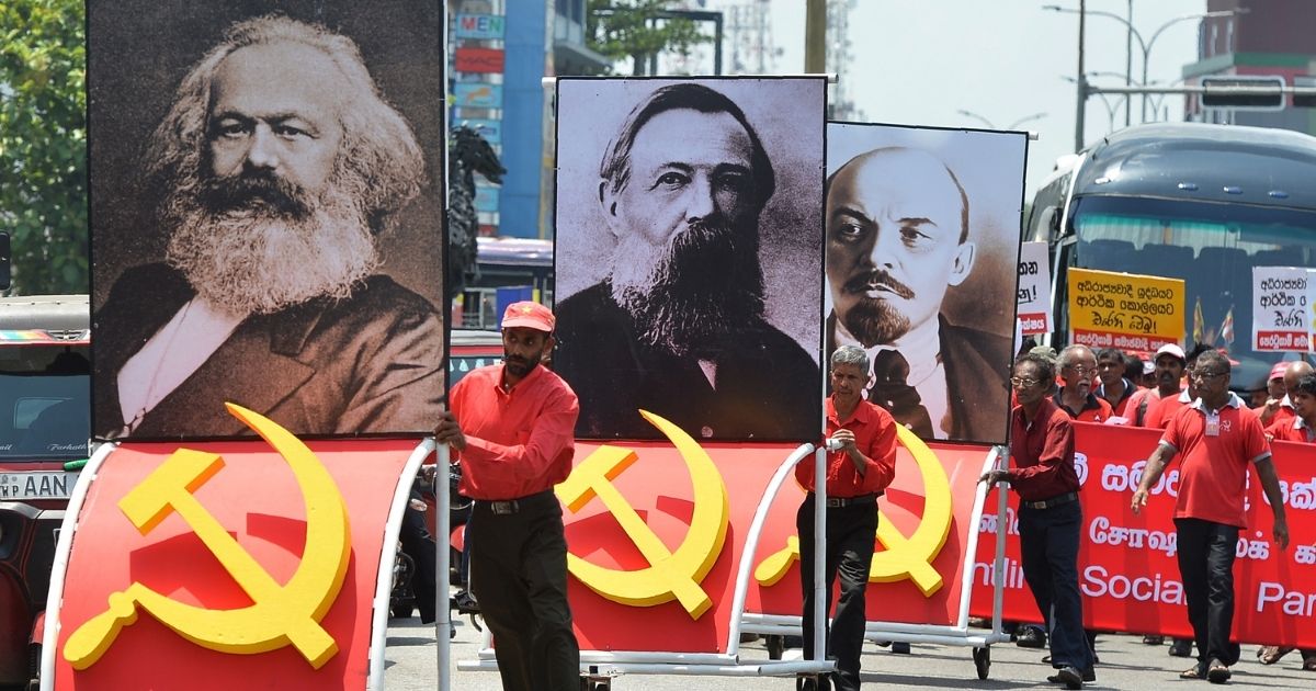 Supporters of the Frontline Socialist Party display placards with images of Karl Marx, left, Friedrich Engels, center, and Vladimir Lenin as they take part on a May Day rally in Colombo on May 1, 2018.