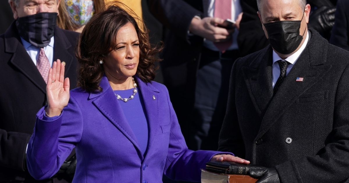 Kamala Harris, dressed in purple, is sworn as vice president by Supreme Court Associate Justice Sonia Sotomayor as her husband, Doug Emhoff, looks on at the inauguration of President Joe Biden at the U.S. Capitol in Washington on Wednesday.