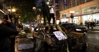 Protesters riot in the streets expressing outrage over the death of George Floyd on May 30, 2020, in Seattle.