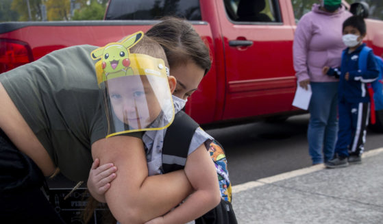 Vanessa Mendez hugs her son, Evan Seppa, as he prepares to head into Elizabeth Page Elementary School for his first day of kindergarten in Springfield, Oregon, on Sept. 21, 2020.