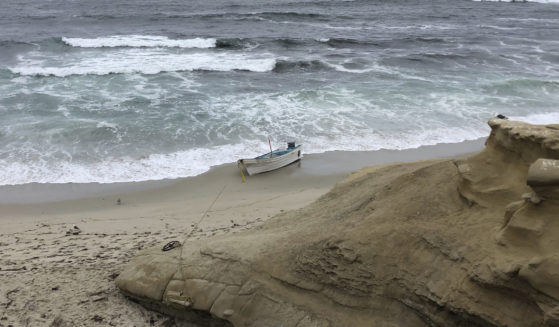 A small boat used during a suspected human smuggling operation sits on a San Diego beach on Thursday.