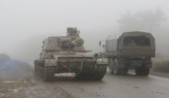 An Armenian self-propelled artillery unit rolls on a road during the withdrawal of Armenian troops from the separatist region of Nagorno-Karabakh, on Nov. 18, 2020.