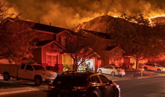 Flames come close to houses during the Blue Ridge Fire on Oct. 27, 2020, in Chino Hills, California.