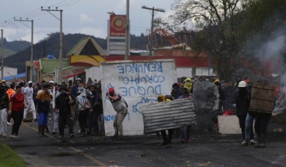 Anti-government protesters clash with police in Gachancipa, Colombia, on Friday.