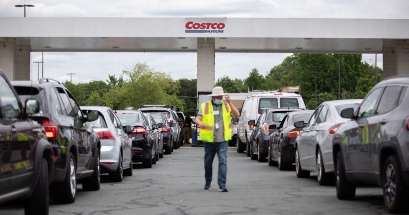 Attendants direct cars as they line up to fill their gas tanks at a Costco on Tyvola Road in Charlotte, North Carolina, on May 11.