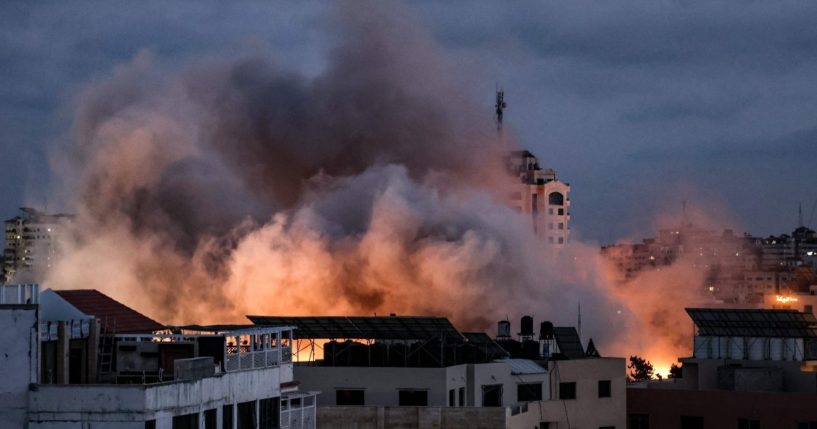 Smoke billows above buildings during an Israeli airstrike on Gaza City on Thursday.