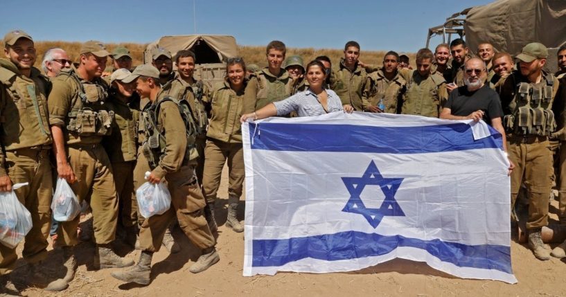 Israelis pose with soldiers along the border in the southern Israeli city of Sderot on Wednesday.