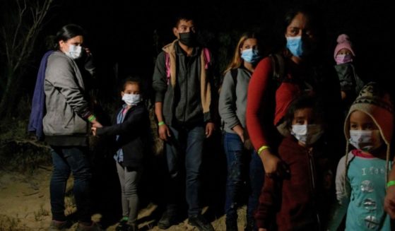 Migrants from Central America, who arrived illegally from Mexico to the U.S. to seek asylum, rest after arriving on an inflatable boat across the Rio Grande river at the border city of Roma on March 29, 2021.